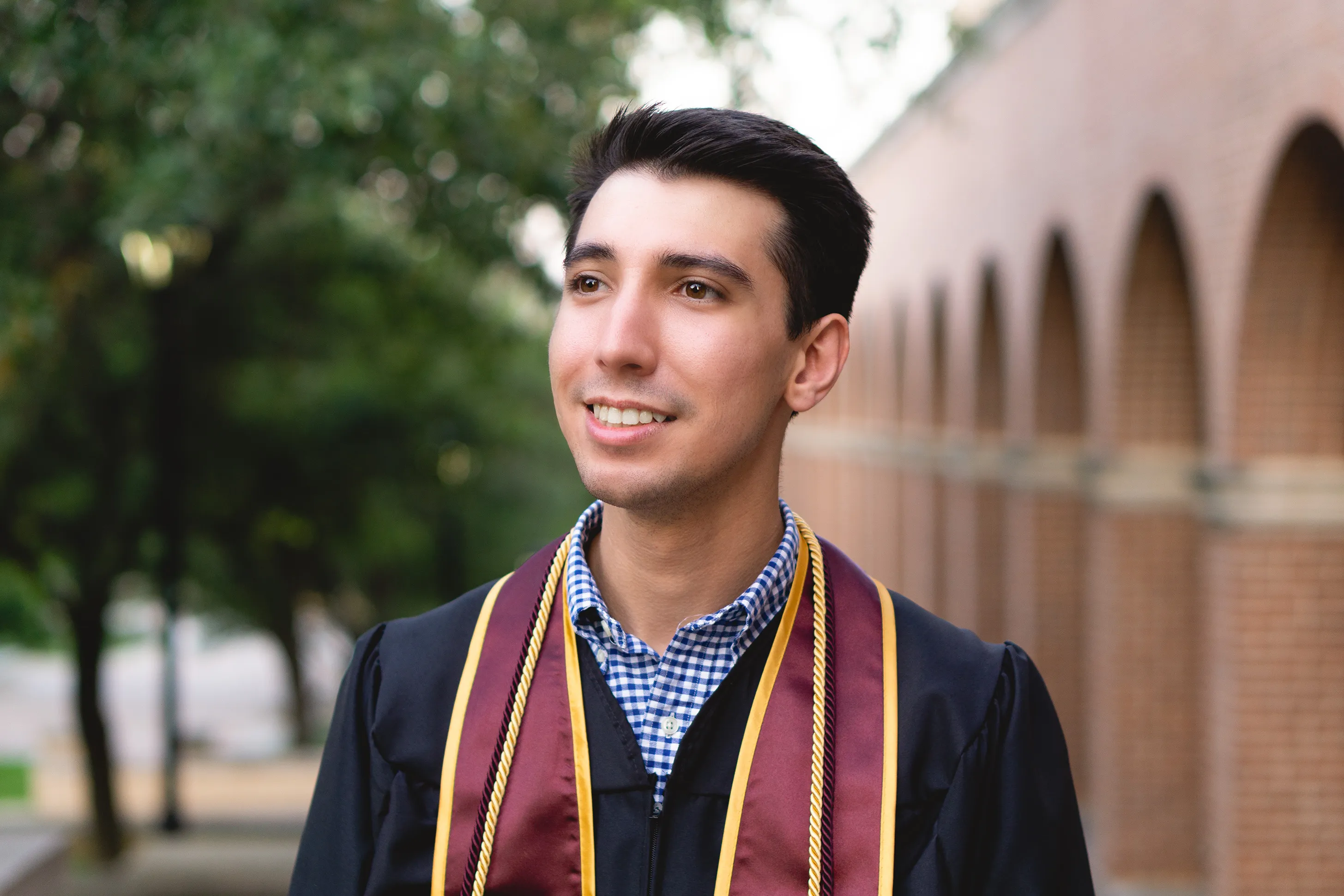 Jonathan Falcon smiling while looking away from the camera.